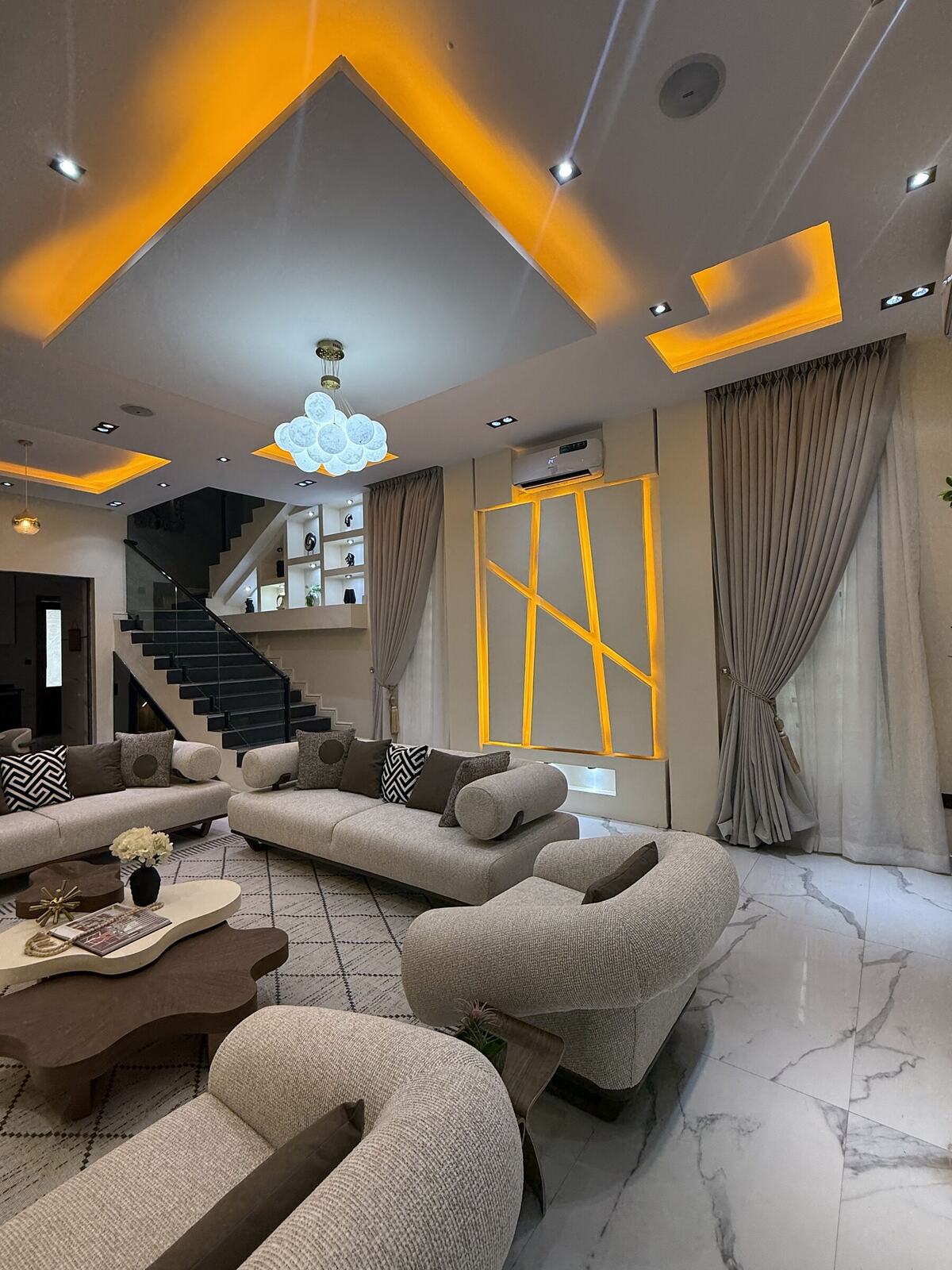 Living room with backlit geometric wall panel